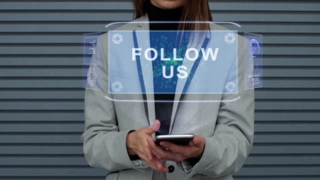 Business-woman-interacts-HUD-hologram-Follow-us
