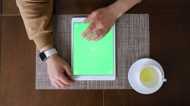 Hands-typing-on-a-tablet-with-chroma-key