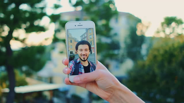 Close-up-of-man-speaking-on-video-call-on-smartphone