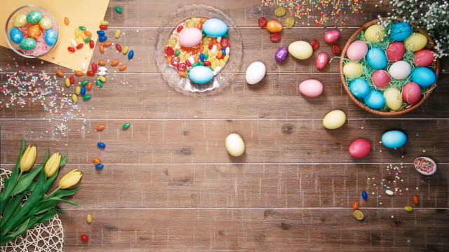 Easter-egg-spins-on-table-decorated-with-easter-eggs.-Top-view