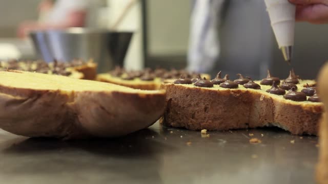 Pastry-Chef-Hände-gefüllt-Osterkuchen-süßes-Brot-mit-Schokolade,-Nahaufnahme-auf-der-Arbeitsplatte-in-der-Konditorei