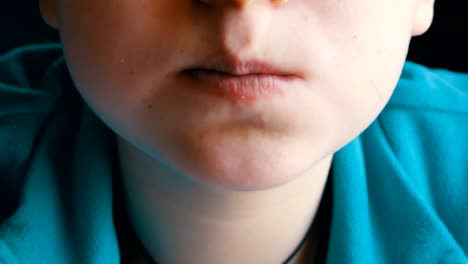 Close-up-view-of-teenager's-mouth.-A-boy-with-an-appetite-is-eating-a-french-fries-in-a-fast-food-restaurant