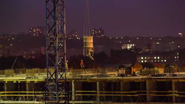 Builders-work-on-construction-site-at-night