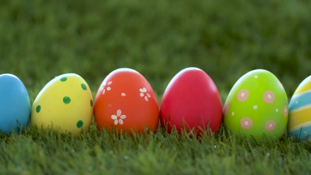 row-of-colored-easter-eggs-on-artificial-grass