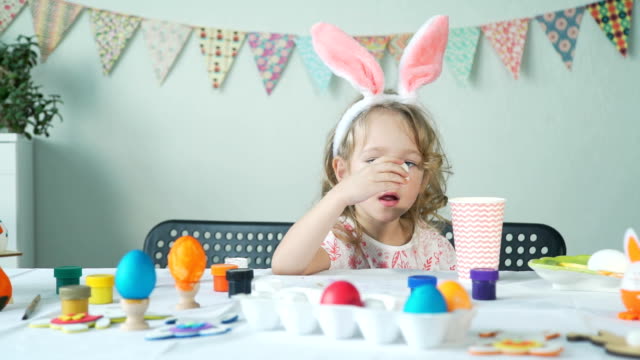 Little-Girl-Eating-Egg-After-Easter-Preparations