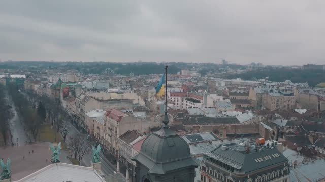 Aerial-Shot-Ukrainian-Flag-Flying-on-Top-of-Lviv-Opera.-European-City.