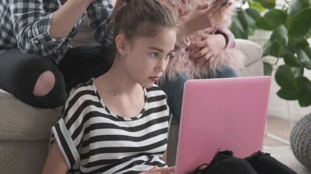 Teenage-girls-using-laptop-and-mobile-phones