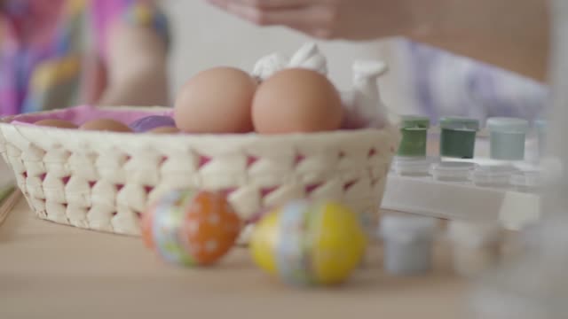 Hand-of-a-woman-taking-an-egg-from-the-basket-close-up.