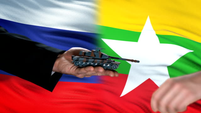Russia-and-Myanmar-officials-exchanging-tank-for-money,-flag-background,-army
