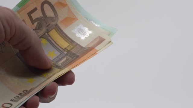 Slow-motion-Close-up-hands-counting-euros-bills-of-fifty-and-one-hundred.