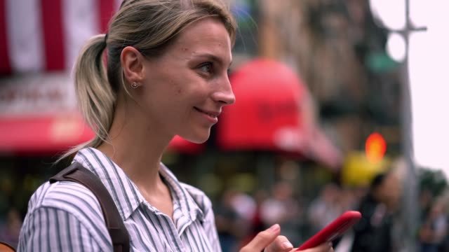 Slow-motion-effect-of-attractive-woman-tourist-checking-information-at-website-with-American-online-guide-during-time-for-exploring-city