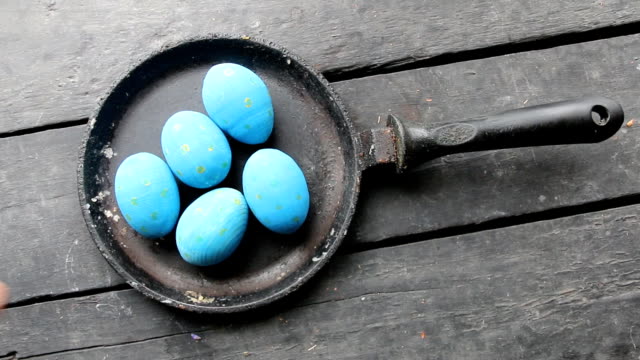 Blue-Easter-eggs-in-a-frying-pan,-art-holiday-decoration