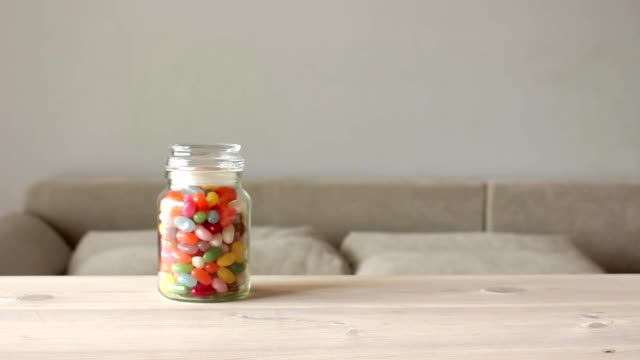 cute-little-boy-takes-jar-of-colorful-candy