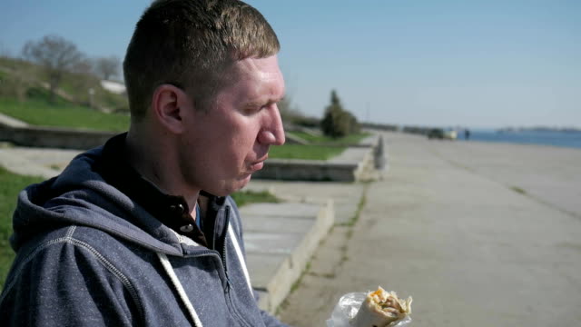 Portrait-of-a-lonesome-male-in-a-wheelchair-eating-shawarma