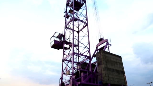 Construction-crane-rising-into-sky,-freight-transportation-equipment,-machine