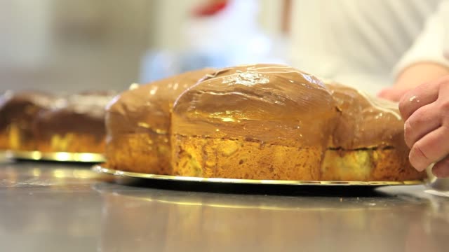 Pastry-Chef-Hände-garnieren-Ostern-süßes-Brot-Kuchen-mit-Fondants-Zucker-paste,-Nahaufnahme-auf-der-Arbeitsplatte-in-der-Konditorei