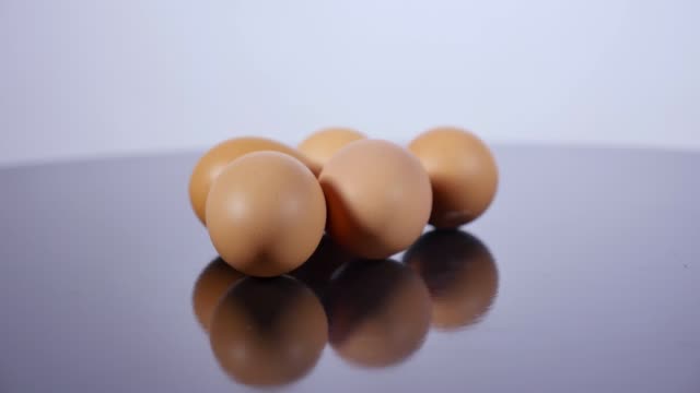 Raw-eggs-lie-on-the-table-and-roll-down