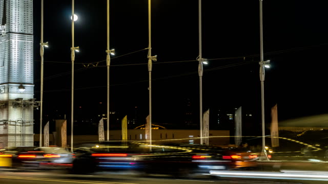 the-moon-rising-above-the-automobile-and-pedestrian-suspension-bridge,-time-lapse