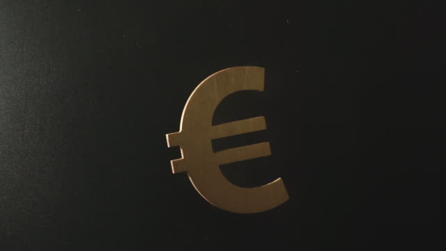 SLOW-MOTION:-Wooden-euro-symbol-falls-in-darkness