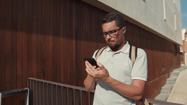 Portrait-of-a-guy-with-smartphone-outside.