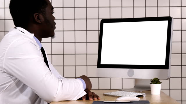 African-doctor-making-video-call-with-his-computer.-White-Display