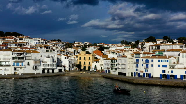 Aerial-panoramic-view-of-Cadaques-Spain.-seagulls-fly-close-to-the-camera.-Video-footage-4K.