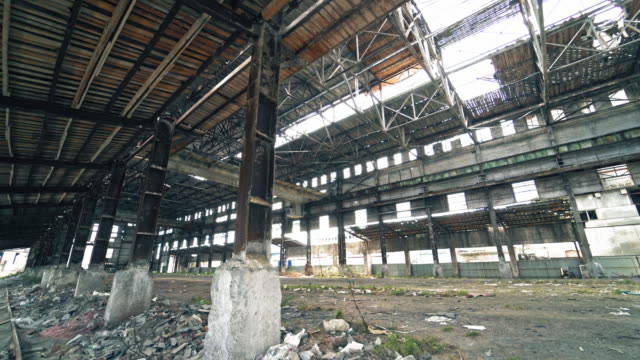 Inside-old-ruined-building-with-collapsed-roof-and-overgrown-with-grass,-catastrophe-or-earthquake-consequences,-toned