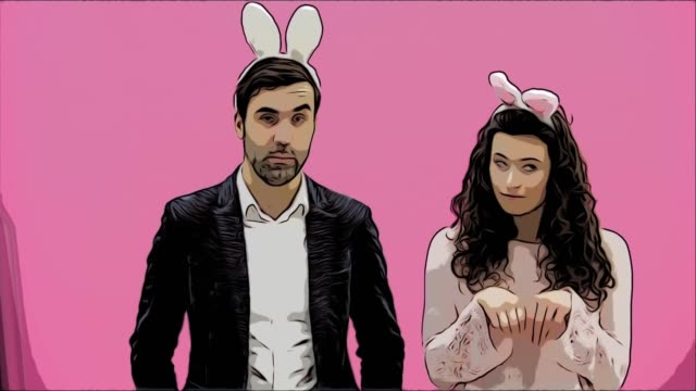Young-couple-standing-standing-on-pink-background.-During-this-time,-they-are-dressed-in-rabble-ears.-Looking-at-each-other-smiles-sincerely.-Easter-Concept.-Animation.