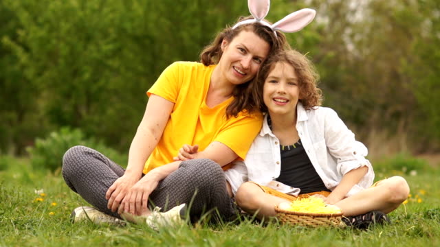 Mom-and-son-at-the-Easter-picnic.-Rabbit-costume.-Curly-family,-happy-family-weekend