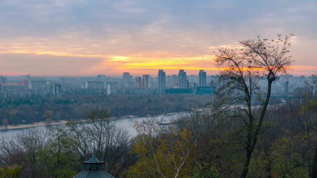 Panorama-of-Kyiv-city-and-Dnipro-river-at-sunrise-in-dawn,-panoramic-view-to-the-colorful-autumn-cityscape-in-the-morning,-Ukraine-4k-time-lapse