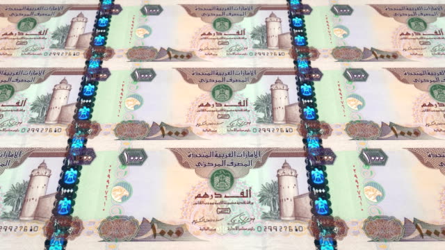 Banknotes-of-one-thousand-dirhams-arabs-of-the-bank-of-the-Arab-Emirates-rolling-on-screen,-coins-of-the-world,-cash-money,-loop