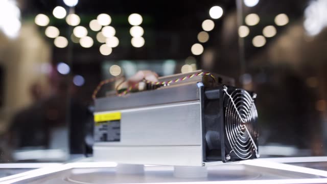 Cryptocurrency-mining-equipment---ASIC---application-specific-integrated-circuit-on-farm-stand-at-expo-or-exhibition