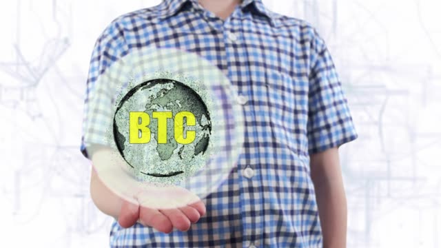 Young-man-shows-a-hologram-of-the-planet-Earth-and-text-BTC