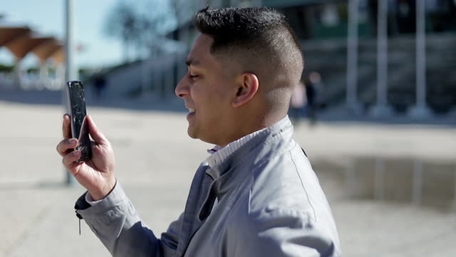 Smiling-young-man-having-video-call-through-broken-smartphone.