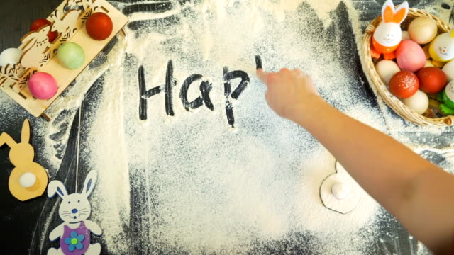 Woman-Writing-`Happy-Easter`-on-a-Flour