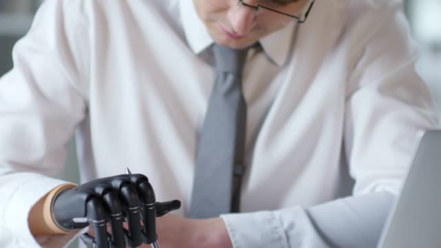 Footage-Compilation-of-Amputee-Businessman-Writing-with-Prosthetic-Hand