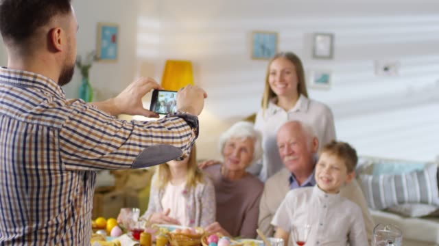 Man-Taking-Smartphone-Photo-of-Family