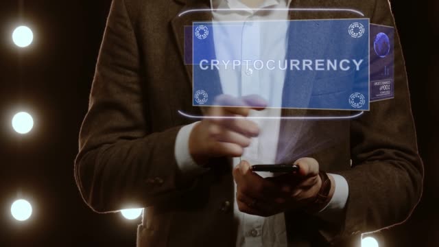 Businessman-shows-hologram-with-text-Cryptocurrency