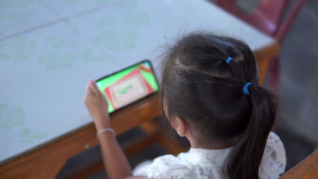 Asien-Mädchen-spielen-Spiel-online-auf-dem-Handy