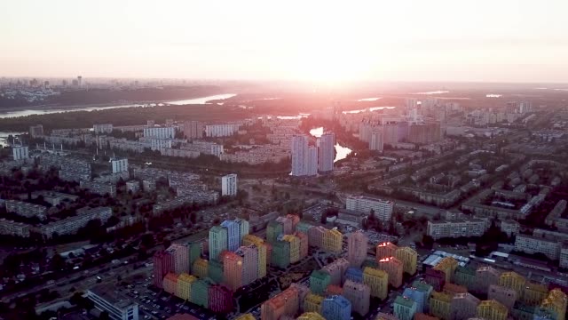 Colorful-buildings-of-a-residential-district,-aerial-shot-from-a-drone-at-sunset-over-Comfort-Town.-Kiev,-Ukraine