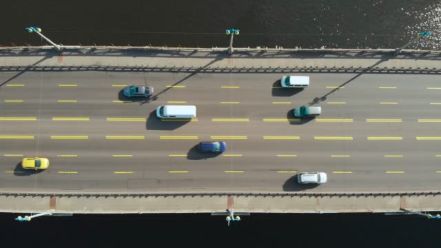 Bridge-over-water-with-moving-cars,-flat-lay