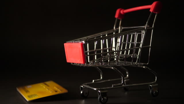 Kreditkarte-fällt-auf-Mini-Einkaufswagen