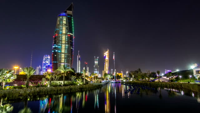 Music-fountains-in-park-with-Kuwait-City-cityscape-night-timelapse-hyperlapse