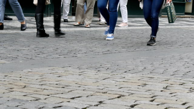 Lot-of-feet-a-crowd-of-people-strolling-along-the-cobbles-of-the-city