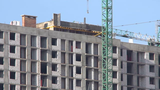 Construction-of-a-high-rise-apartment-house.-The-construction-crane-works-at-the-construction-site.-Construction-of-new-residential-property