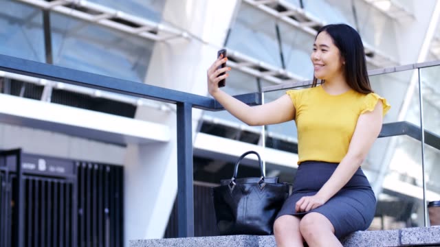 Young-business-lady-making-selfies-on-mobile-phone