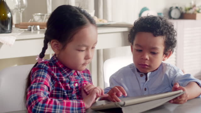 Mixed-Raced-Kids-Using-Tablet-Together