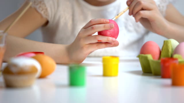 Child-painting-color-eggs-brush,-decorating-Easter-symbol,-preparation-festival