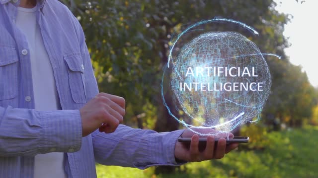 Unrecognizable-man-shows-conceptual-hologram-with-text-Artificial-Intelligence