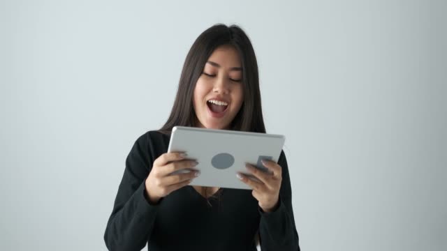 Woman-playing-game-on-digital-tablet